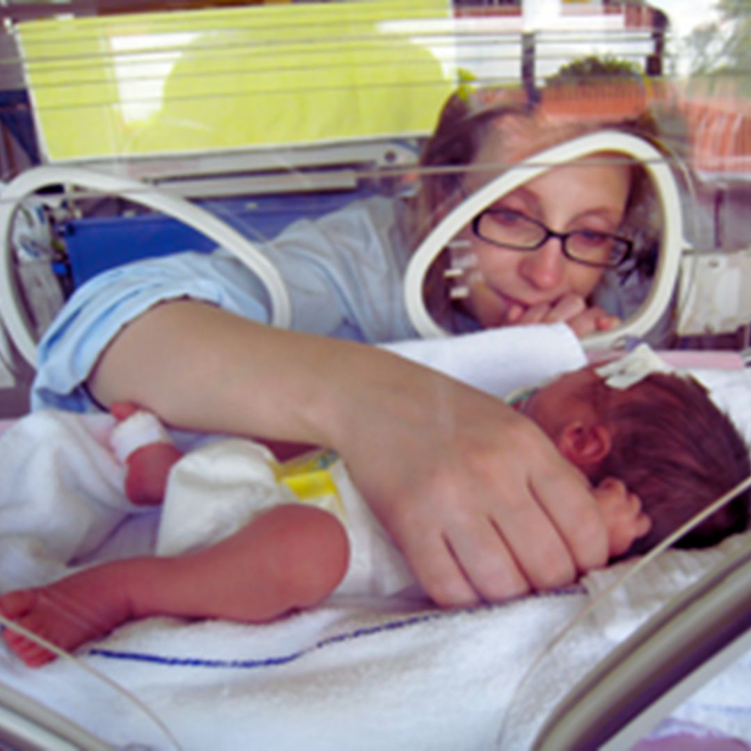 mother-gazing-at-and-holding-the-hand-of-a-premature-infant-in-an-incubator-(St-Lukes-Kansas-City-2020).jpg mother-gazing-at-and-holding-the-hand-of-a-premature-infant-in-an-incubator-(St-Lukes-Kansas-City-2020).jpg